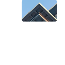 Rooftop corner of a modern building against a blue sky inside a rounded frame