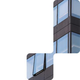 Dark office building facade with blue glass windows masked into stepped rounded blocks